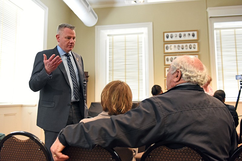 Retired Army Col. Marcus Jones (left) visits with John R. and Elaine Watts of Little Rock during his news conference at the MacArthur Museum of Arkansas Military History in Little Rock on Thursday, March 28, 2024. (Arkansas Democrat-Gazette/Staci Vandagriff)