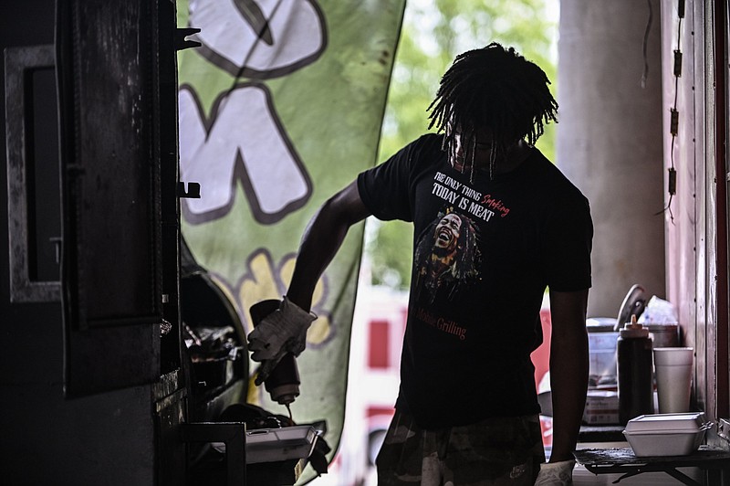 Bryce Jefferson of Jefferson’s Mobile Grilling prepares an order during the Wings on the River event at the River Market Pavilion in downtown Little Rock on Sunday, July 28, 2024. (Arkansas Democrat-Gazette/Staci Vandagriff)