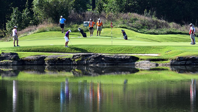 Staff photo by Robin Rudd / Play on the eighth green at the Honors Course is reflected in a watercolor pattern on a pond during the 69th U.S. Junior Amateur Championship in July 2016. The Ooltewah course will host another USGA national championship tournament, the 69th U.S. Senior Amateur, on Aug. 24-29.