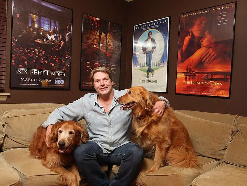 Yancey Prosser poses with his dogs Lucy (left) and Izzie in the media room of his Little Rock home in 2011. (Arkansas Democrat-Gazette file photo)