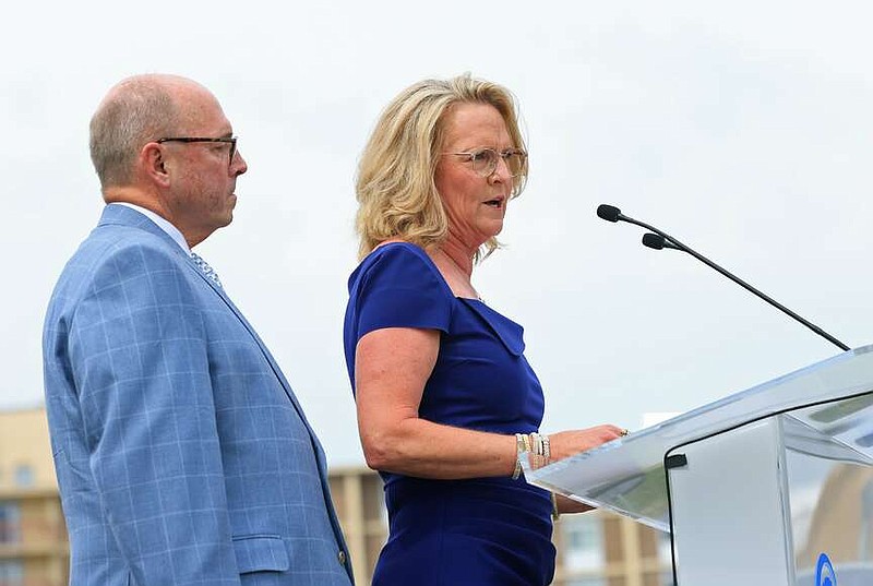 Lynn Parker, center, is joined by her husband Don Parker as she speaks during an event celebrating their family's donation of an additional $2 million to an expansion project at the Arkansas Children's Hospital in Little Rock on Monday, July 22, 2024. (Arkansas Democrat-Gazette/Colin Murphey)