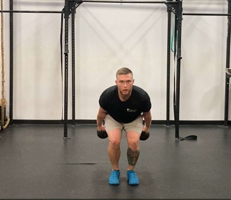 In this first of three photos, JD Stephenson demonstrates the Double Kettlebell Swing for Matt Parrott's Master Class. (Arkansas Democrat-Gazette/Kimberly Dishongh) (To run 7/29/24)