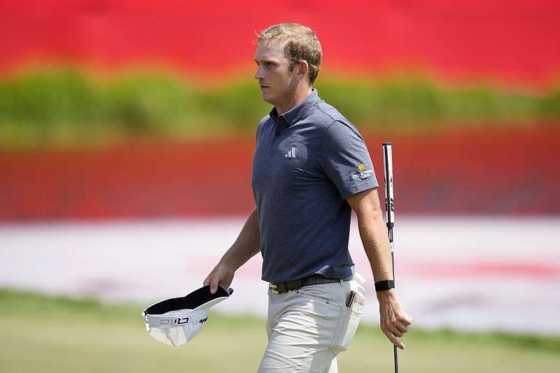 Jacob Bridgeman walks on the 18th green after making a birdie putt during the first round of the 3M Open golf tournament at the Tournament Players Club, Thursday, July 25, 2024, in Blaine, Minn. (AP Photo/Charlie Neibergall)