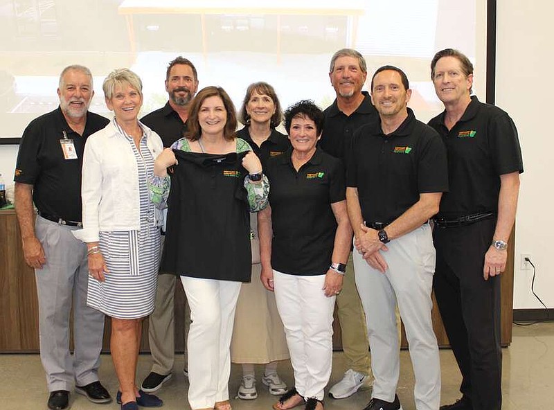 Northwest Arkansas Food Bank President and CEO Kent Eikenberry and wife Diana (from left) and Tim Harris, Gayla Harris, Paula Harris Stansell, Theresa Moore, Don Harris, Gary Harris and David Harris welcome guests to celebration July 31 in celebration of the opening of the Claude and Betty Harris Center for Hunger Relief,  which is named in honor of their parents.  
(NWA Democrat-Gazette/Carin Schoppmeyer)