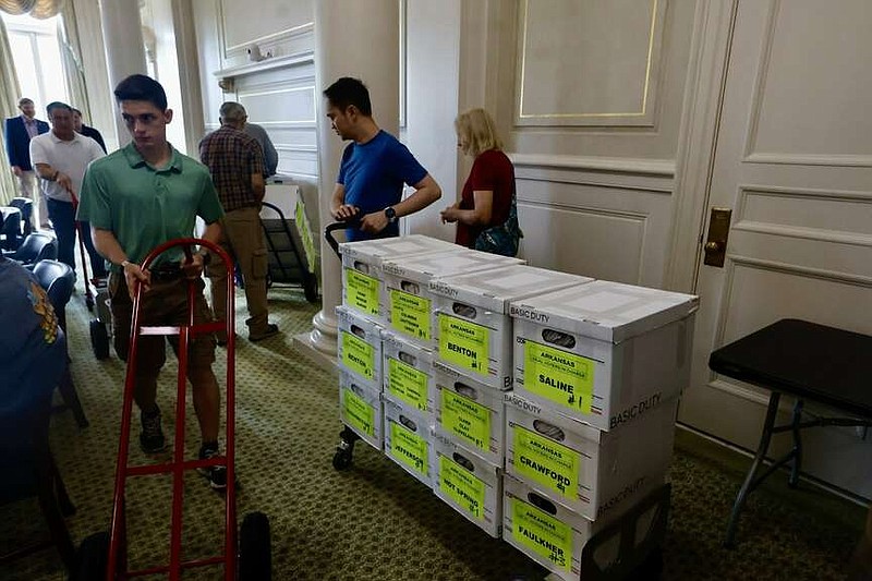 FILE - Volunteers deliver signatures for the repeal Pope County casino amendment at the state Capitol on July 5.  (Arkansas Democrat-Gazette/Thomas Metthe)