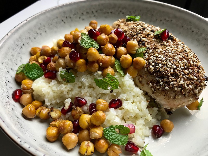 Coriander-Crusted Chicken With Crispy Chickpeas and Pomegranate with riced cauliflower. (Arkansas Democrat-Gazette/Kelly Brant)