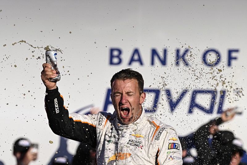 AJ Allmendinger (16) celebrates in Victory Lane after winning a NASCAR Cup Series auto race at Charlotte Motor Speedway, Sunday, Oct. 8, 2023, in Concord, N.C. (AP Photo/Matt Kelley)