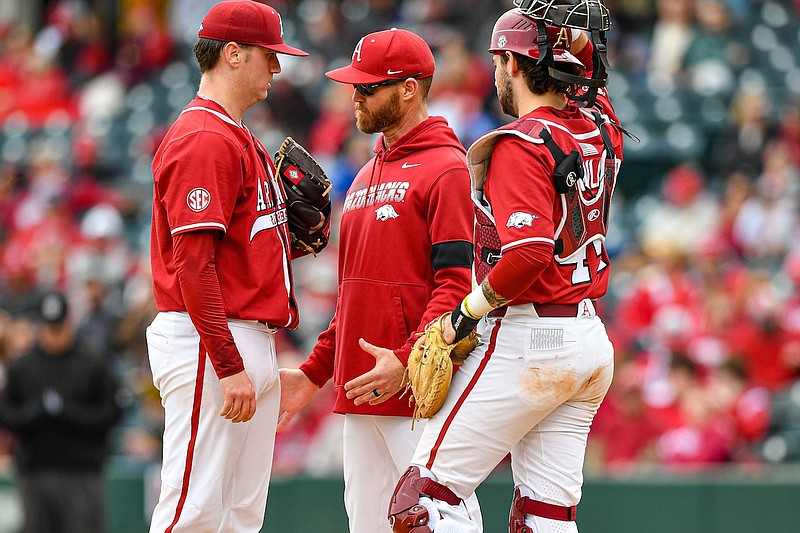 Arkansas pitching coach Matt Hobbs (center) visits with starting pitcher Will McEntire (41) and catcher Parker Rowland (44) on the mound, Saturday, Feb. 25, 2023, during the fifth inning of the Razorbacks’ 10-3 win over the Eastern Illinois Panthers at Baum-Walker Stadium in Fayetteville. (Hank Layton/WholeHogSports)