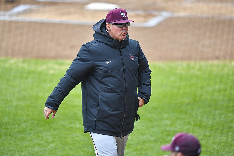 UA-Little Rock head coach Chris Curry walks to the dugout after speaking to umpires, Tuesday, March 26, 2024, during the first inning against Arkansas at Baum-Walker Stadium in Fayetteville. (NWA Democrat-Gazette/Hank Layton)