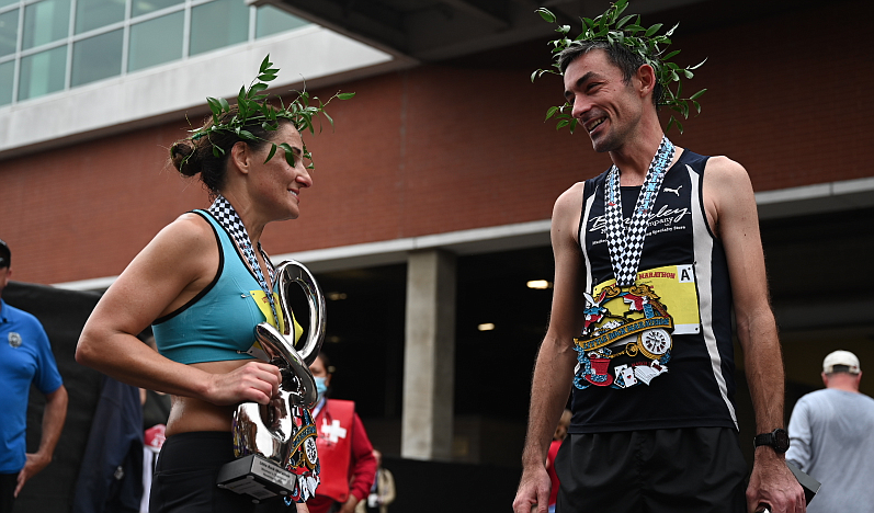 Tia Stone and Joseph Hoch, the women and men winners of the Little Rock marathon, talk with one another after finishing the race on Sunday, November 21, 2021. (Arkansas Democrat-Gazette/Stephen Swofford)